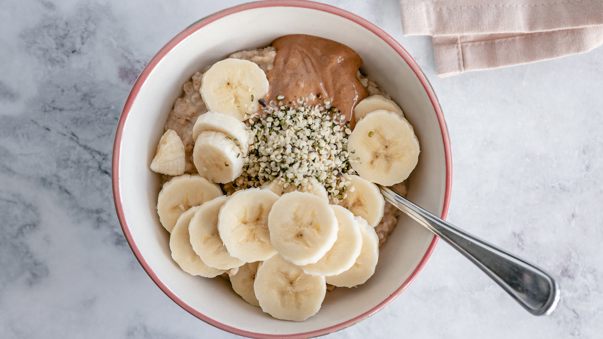 oatmeal with banana and hemp seeds in a bowl