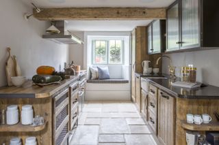 Cottage style galley kitchen with stone floor