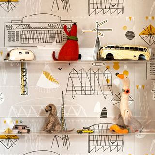 room with wallpaper on wall and toys