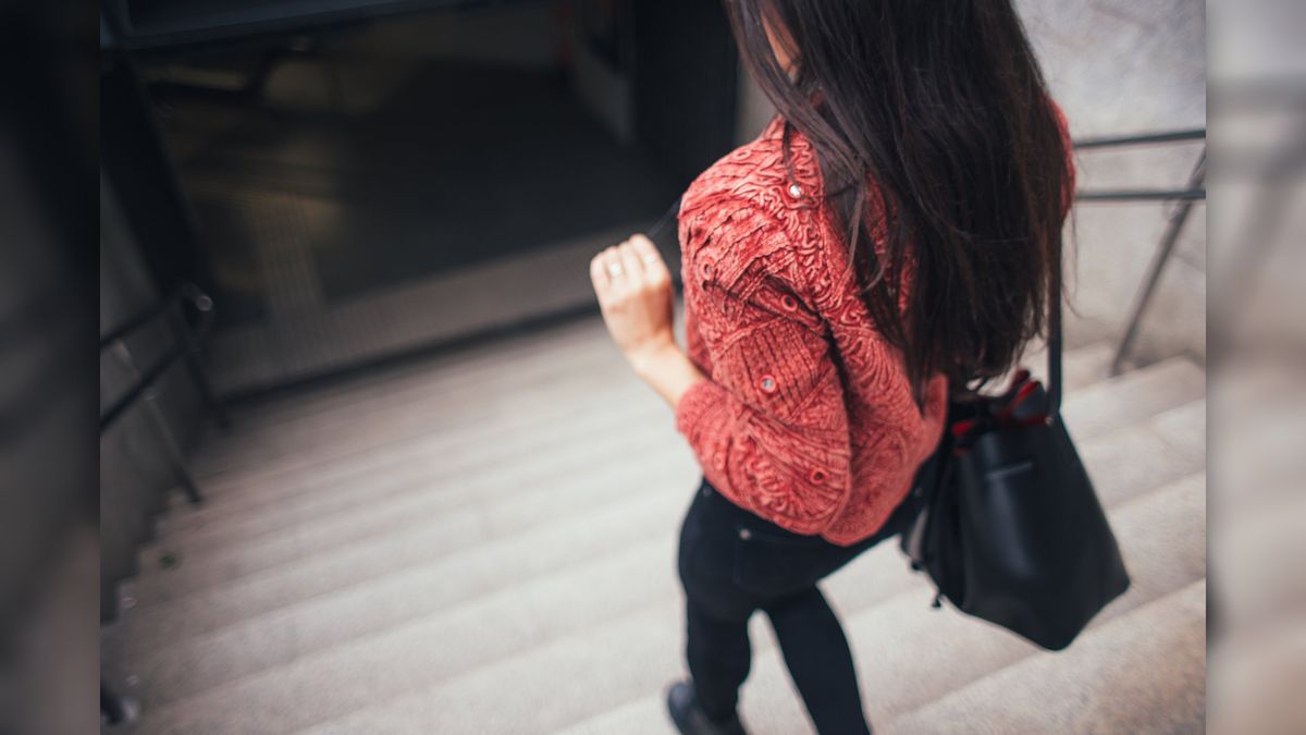 Woman at the top of the stairs.