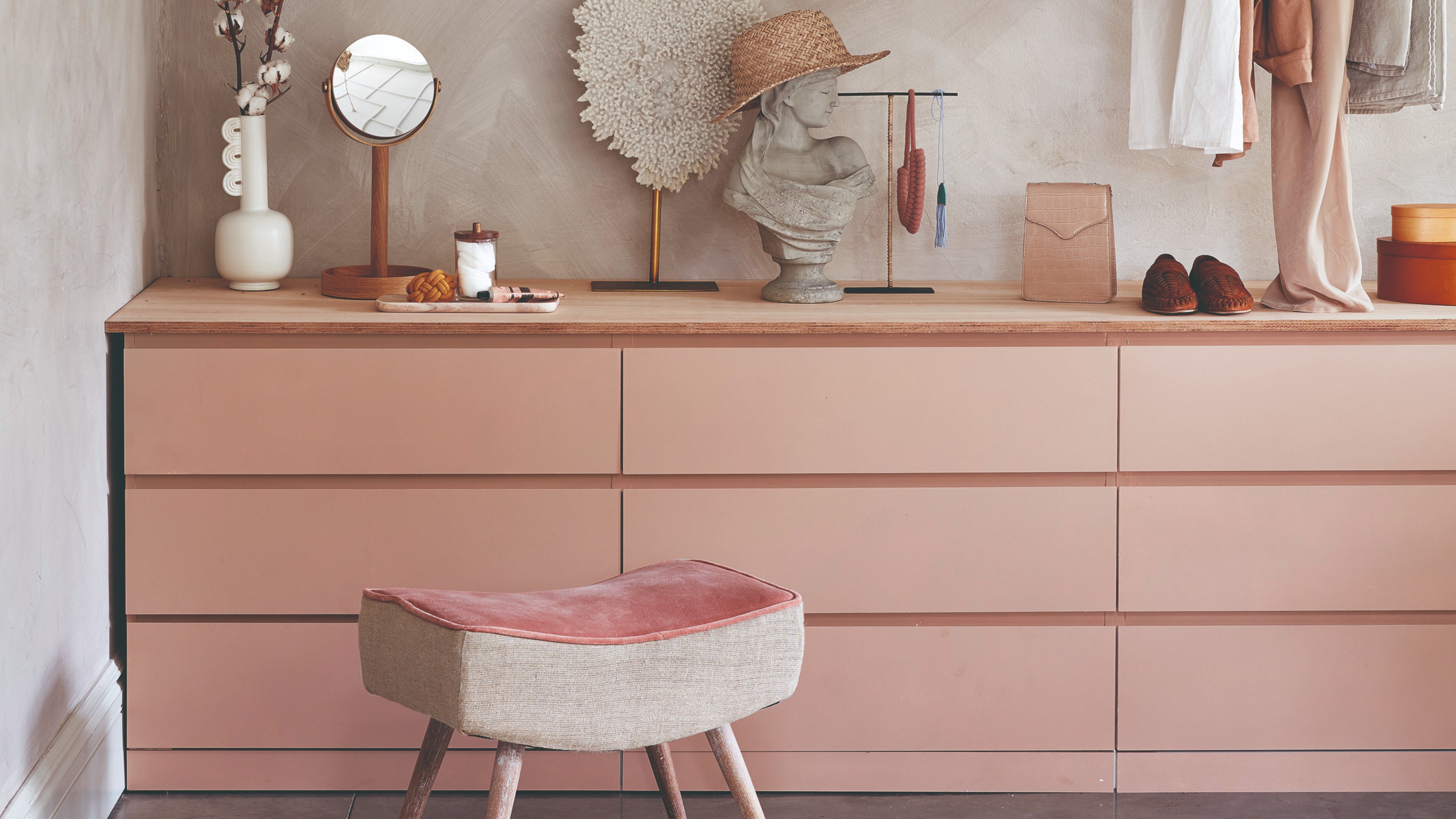 Three pink IKEA MALM chest of drawers next to each other in a dressing room, displaying fashion accessories