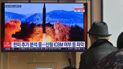 A man watches television coverage of North Korea's failed missile launch.