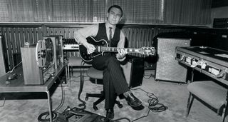 A black-and-white image of Robert Fripp playing his 1959 Gibson Les Paul Custom