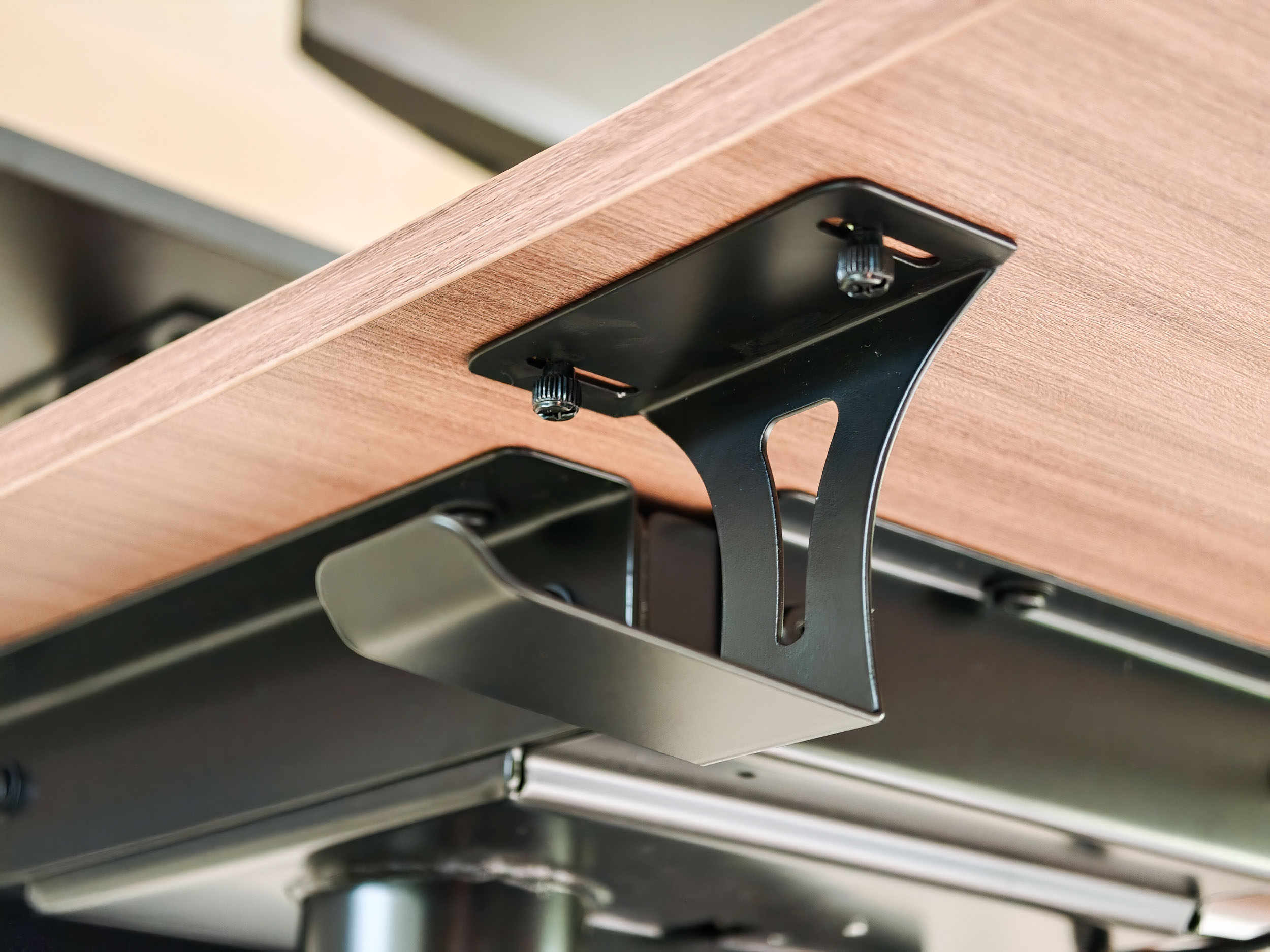Closeup of the Arozzi Arena Nordico Electric Standing Desk's headphone hook accessory