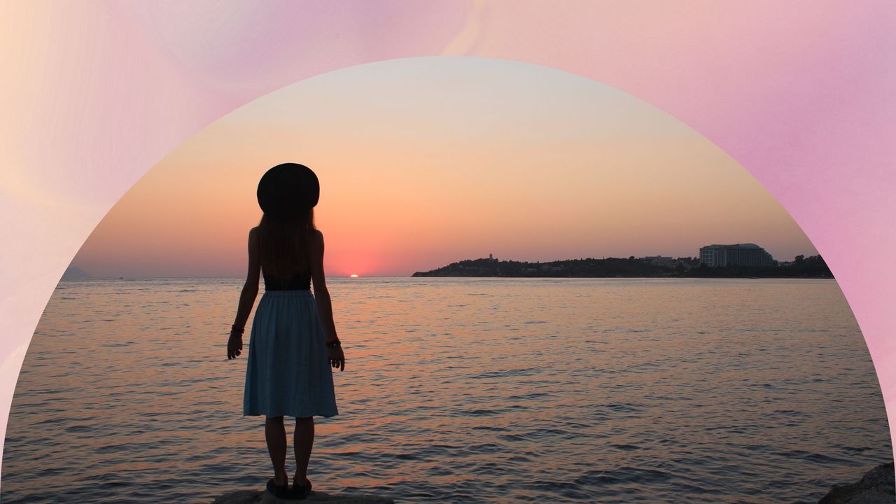 woman&#039;s silhouette at the beach as the sun sets; symbolizing august astrology events