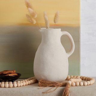 white stoneware jug vase with pampas grass inside
