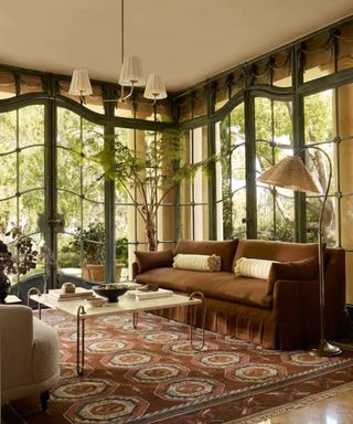 Earthy toned living room with wrap around windows