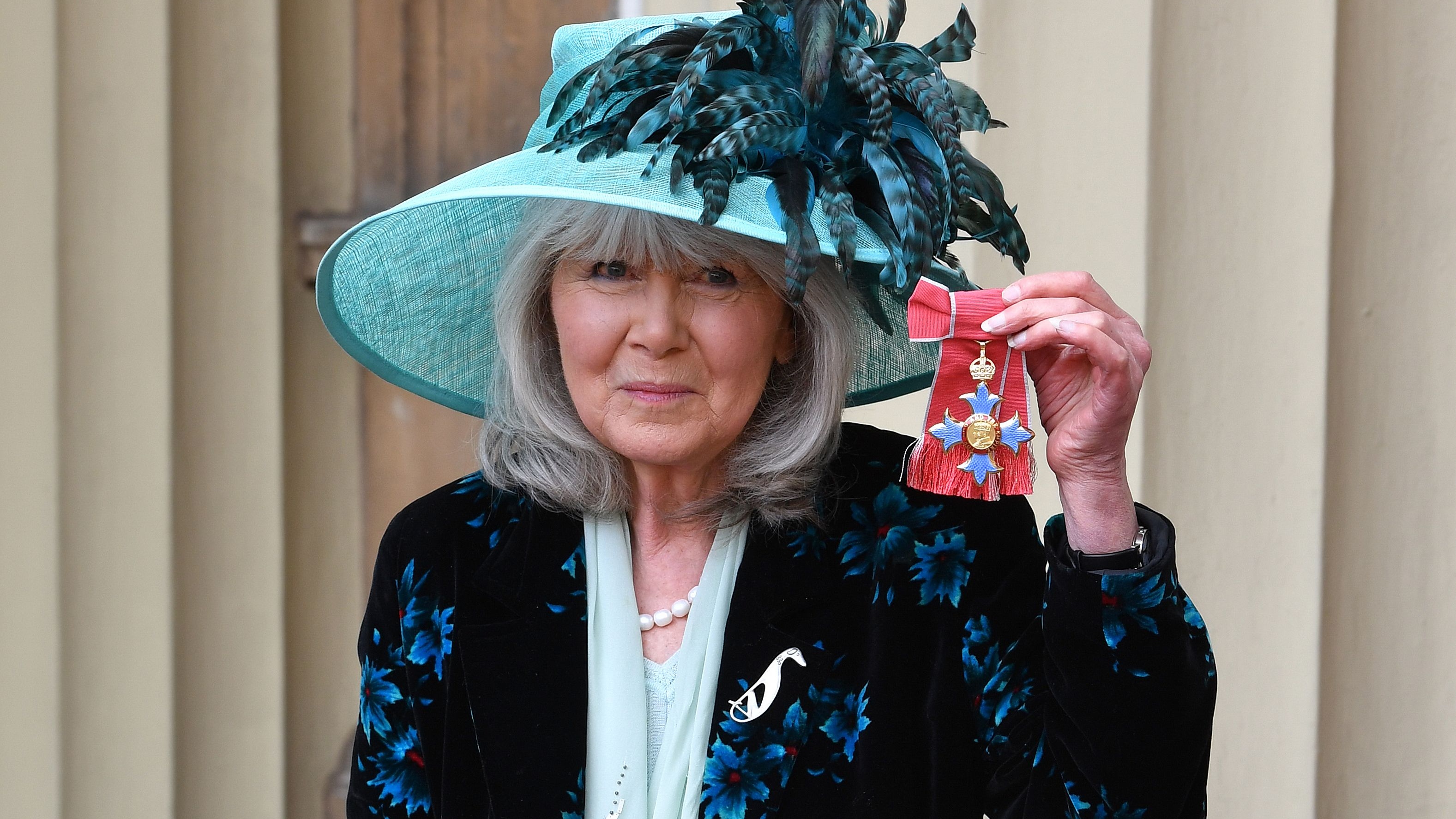 Author Jilly Cooper poses with her medal after she was appointed a Commander of the Order of the British Empire (CBE) at an investiture ceremony at Buckingham Palace in London on March 20, 2018. / AFP PHOTO / POOL / John Stillwell (Photo credit should read JOHN STILLWELL/AFP via Getty Images)