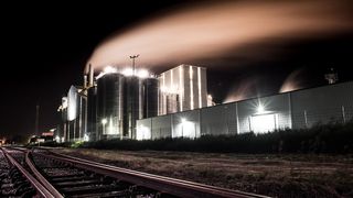 An image of a factory at night - industry and digital technology