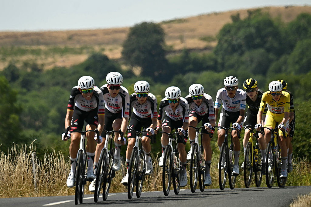 UAE Team Emirates - XRG's Slovenian rider Tadej Pogacar wearing the overall leader's yellow jersey cycles with his teammates ahead of the pack of riders (peloton) during the 10th stage of the 113th edition of the Tour de France cycling race, 166,6 km between Aurillac and Le Lioran in the Massif Central, on July 14, 2026. (Photo by Loic VENANCE / AFP)
