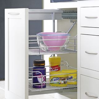 kitchen with white pullout shelf drawer and kitchen utensils