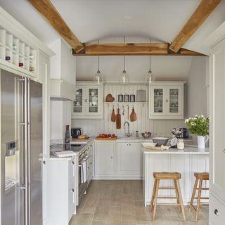 kitchen with white coloured and stools