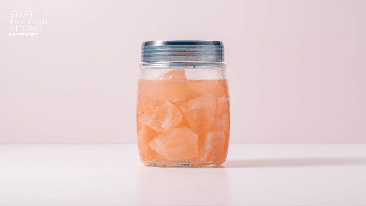 A jar of water with Himalayan salt rocks inside