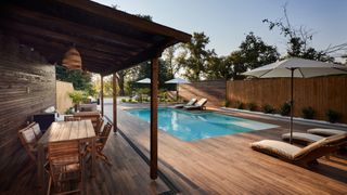 pool area with a dark wooden decked area