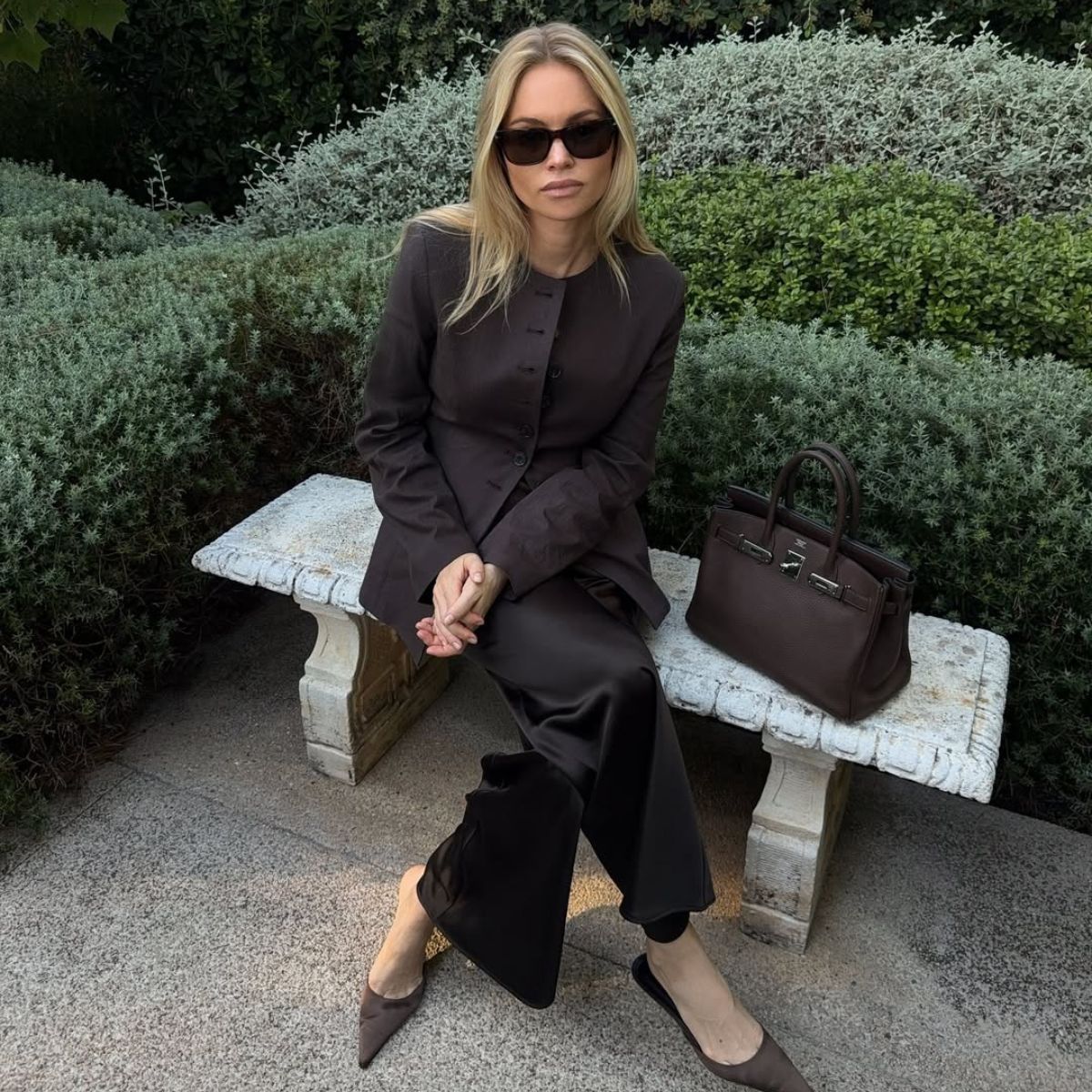claire rose cliteur wears a brown blazer and silk trousers