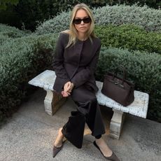 claire rose cliteur wears a brown blazer and silk trousers