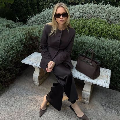 claire rose cliteur wears a brown blazer and silk trousers
