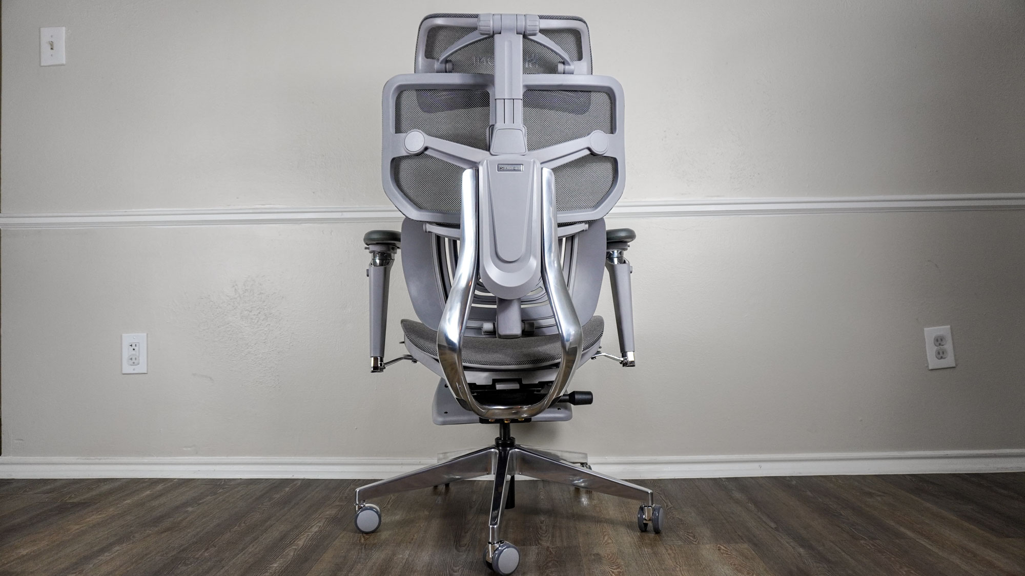 The Hinomi X1 seen from behind showing off its aluminum frame and backrest
