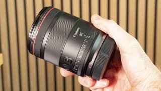 Canon RF 85mm F1.4L VCM lens in photographer's hands