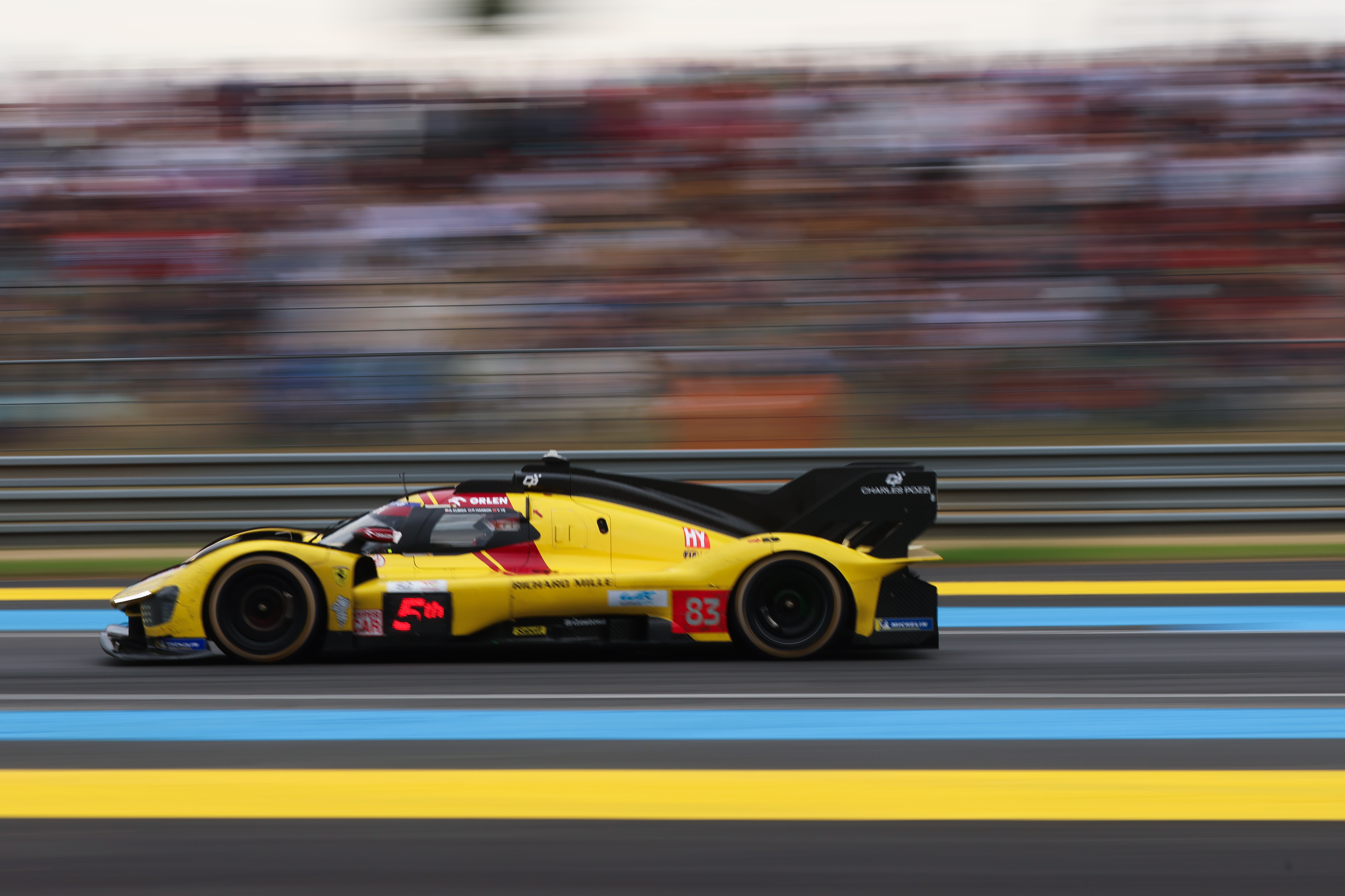 A Ferrari at Le Mans 2025 racing past the grandstands