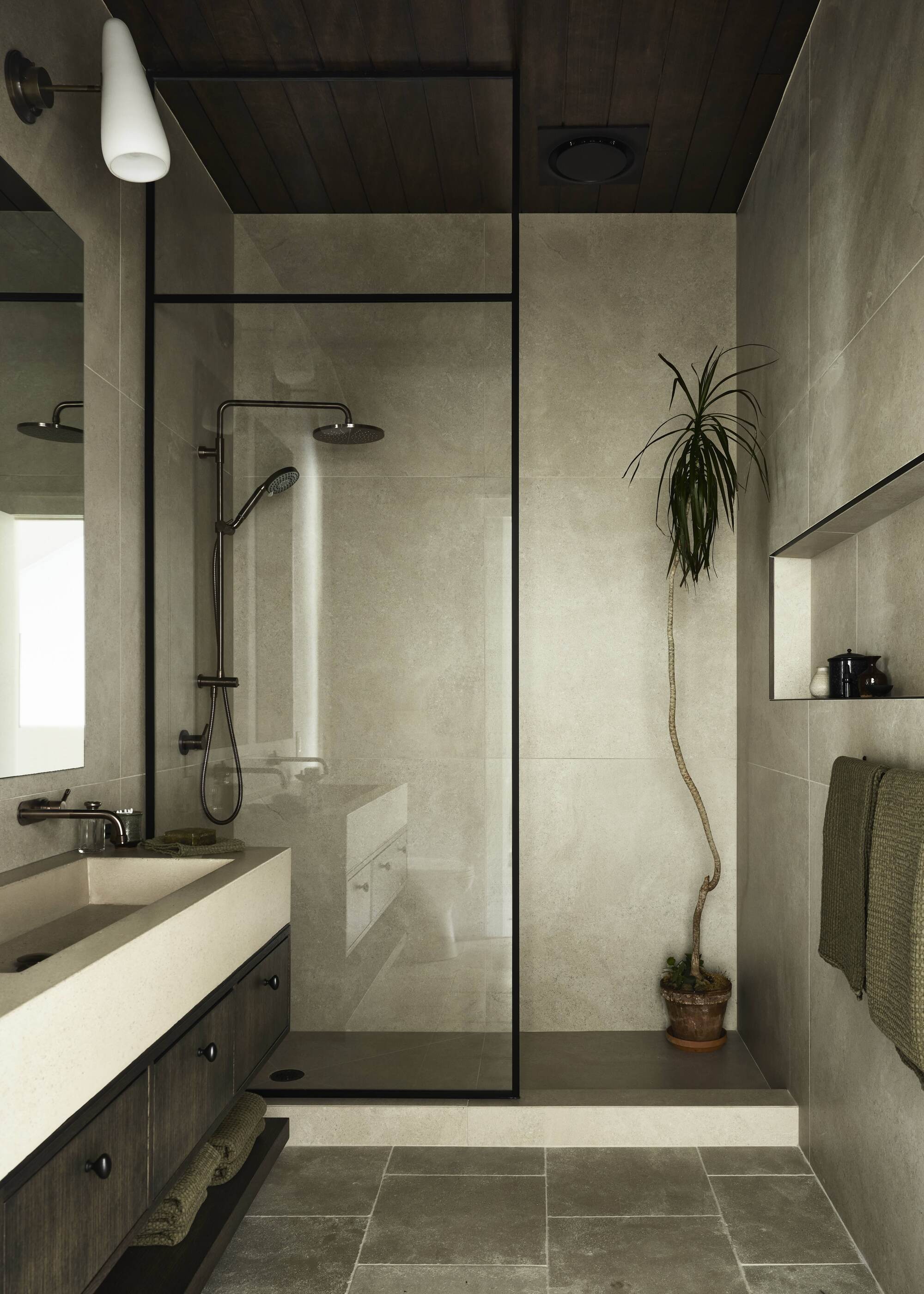 modern bathroom with walk-in shower with a potted plant, flagstone floor tiles, floating timber vanity with ceramic basin and timber clad ceiling