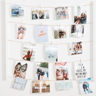 A hanging photo holder with photos on it