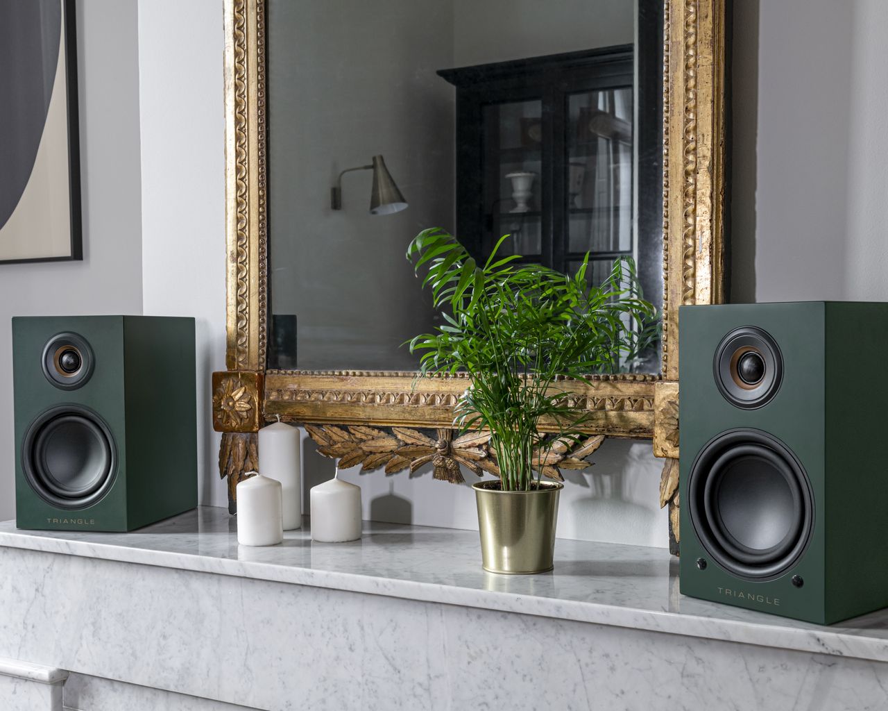 Spotify vs Apple Music Triangle speakers shown on top of a fireplace mantel