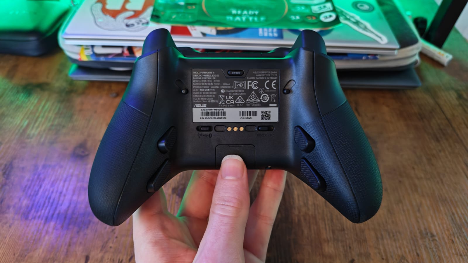 A reviewer showcasing the back of the Asus ROG Raikiri 2