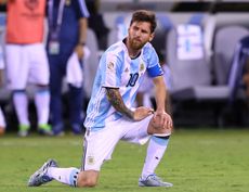 Lionel Messi takes a knee