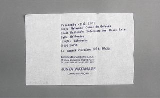 View of ﻿Junya Watanabe's tissue paper invitation pictured against a grey background