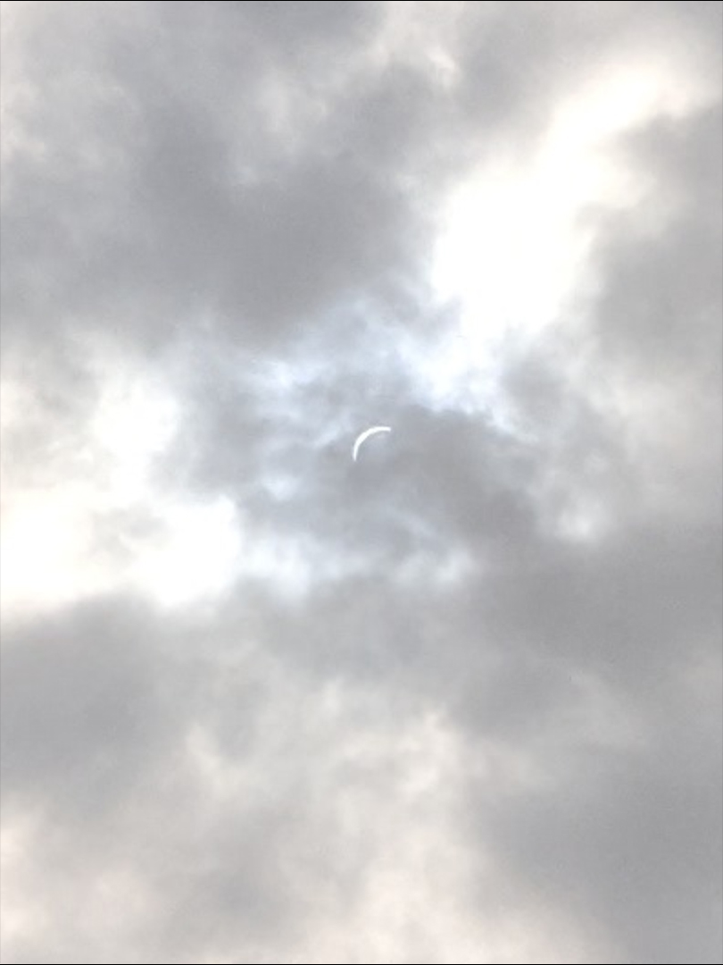 A view of the partial solar eclipse through clouds shortly before the start of totality.