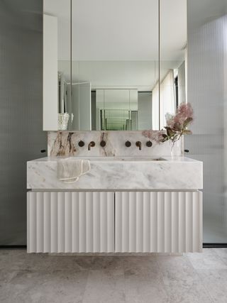 A bathroom with marble countertop