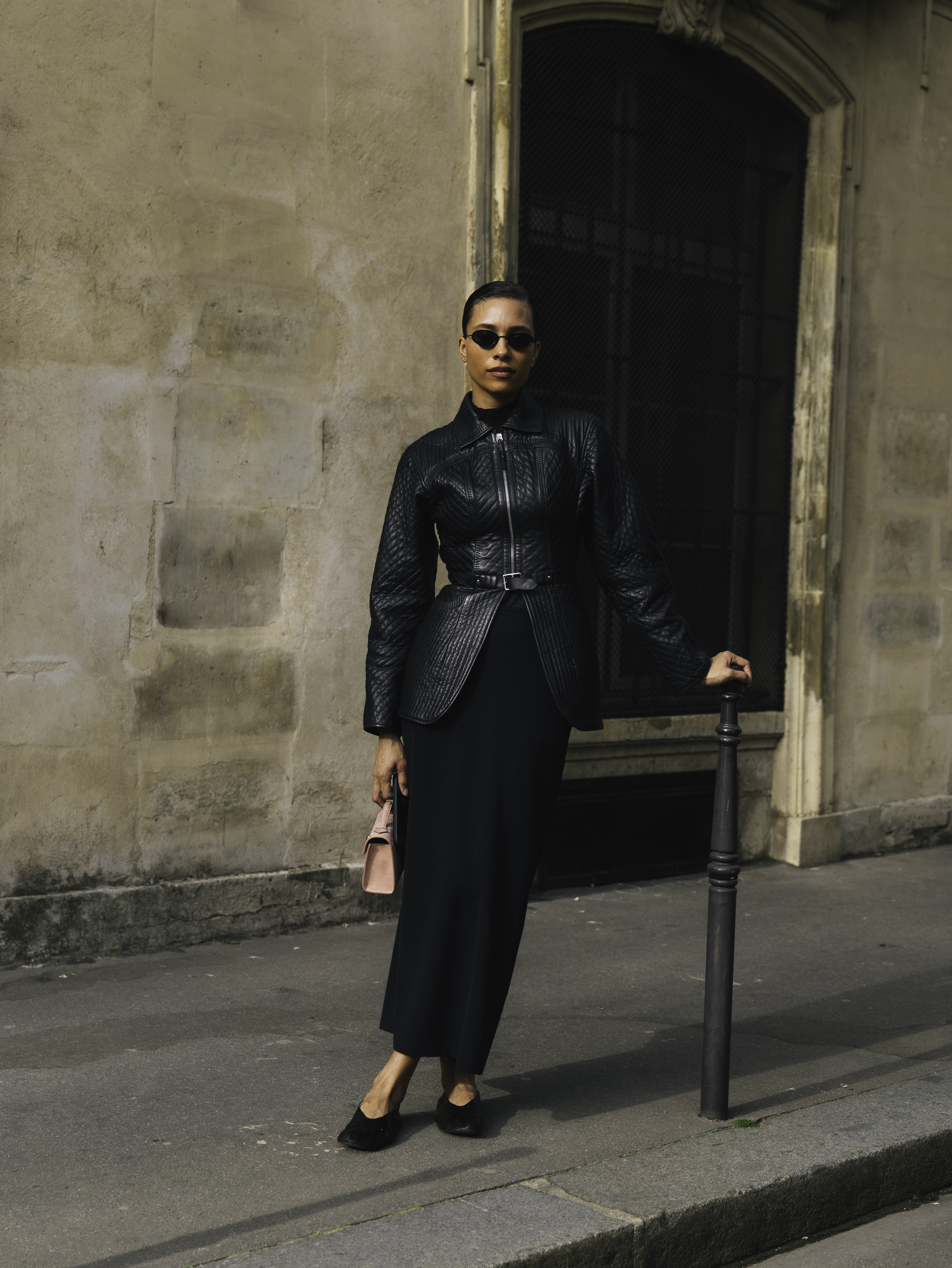 woman wearing leather jacket, skirt, and jeans