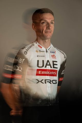 Adam Yates in the new UAE Team Emirates 2025 kit, which is largely white, with black arms