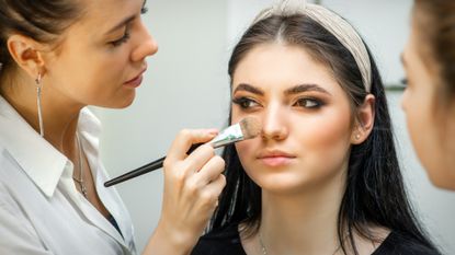 woman applying cream bronzer