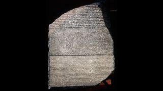 Ancient Egyptian Rosetta Stone. It is a giant stone with 3 types of writing carved onto it: Greek, Egyptian, and another form of Egyptian writing.