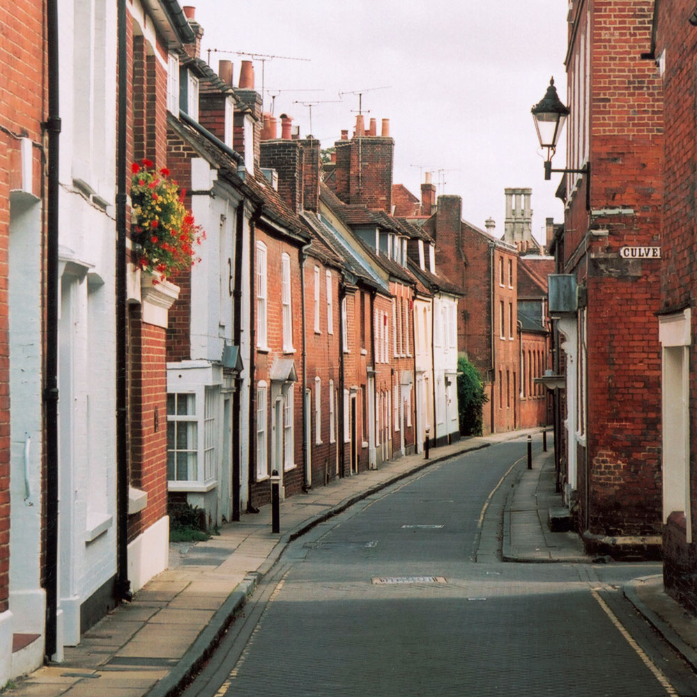red brick wall house street and street lamp