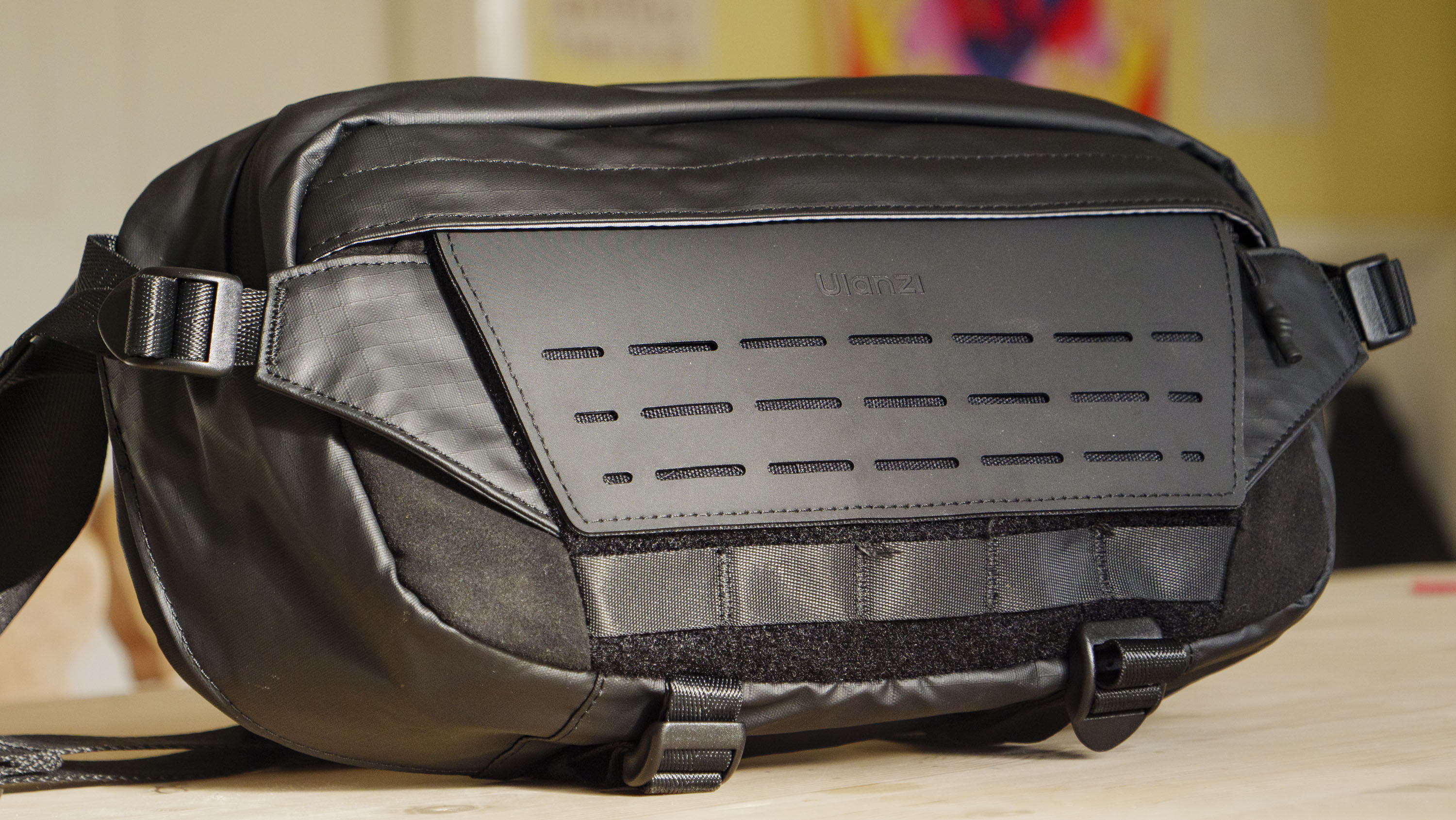 The Ulanzi Camera Sling Bag on a wooden table, front