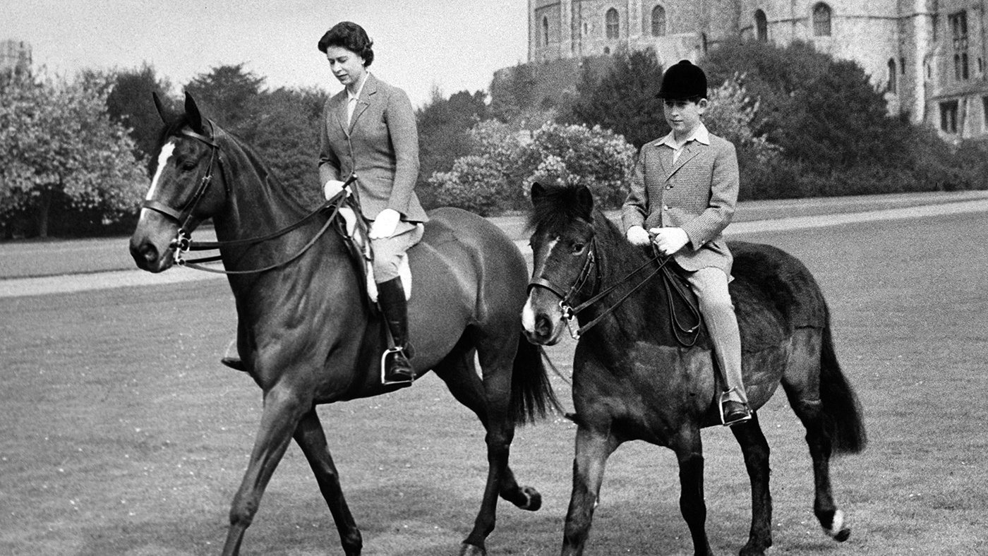 Undated picture showing Queen Elizabeth II of England and Prince Charles riding horses in the park of Windsor Castle. (Photo by - / CENTRAL PRESS PHOTO LTD / AFP) (Photo credit should read -/AFP via Getty Images)