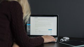 woman working on laptop with WordPress CMS
