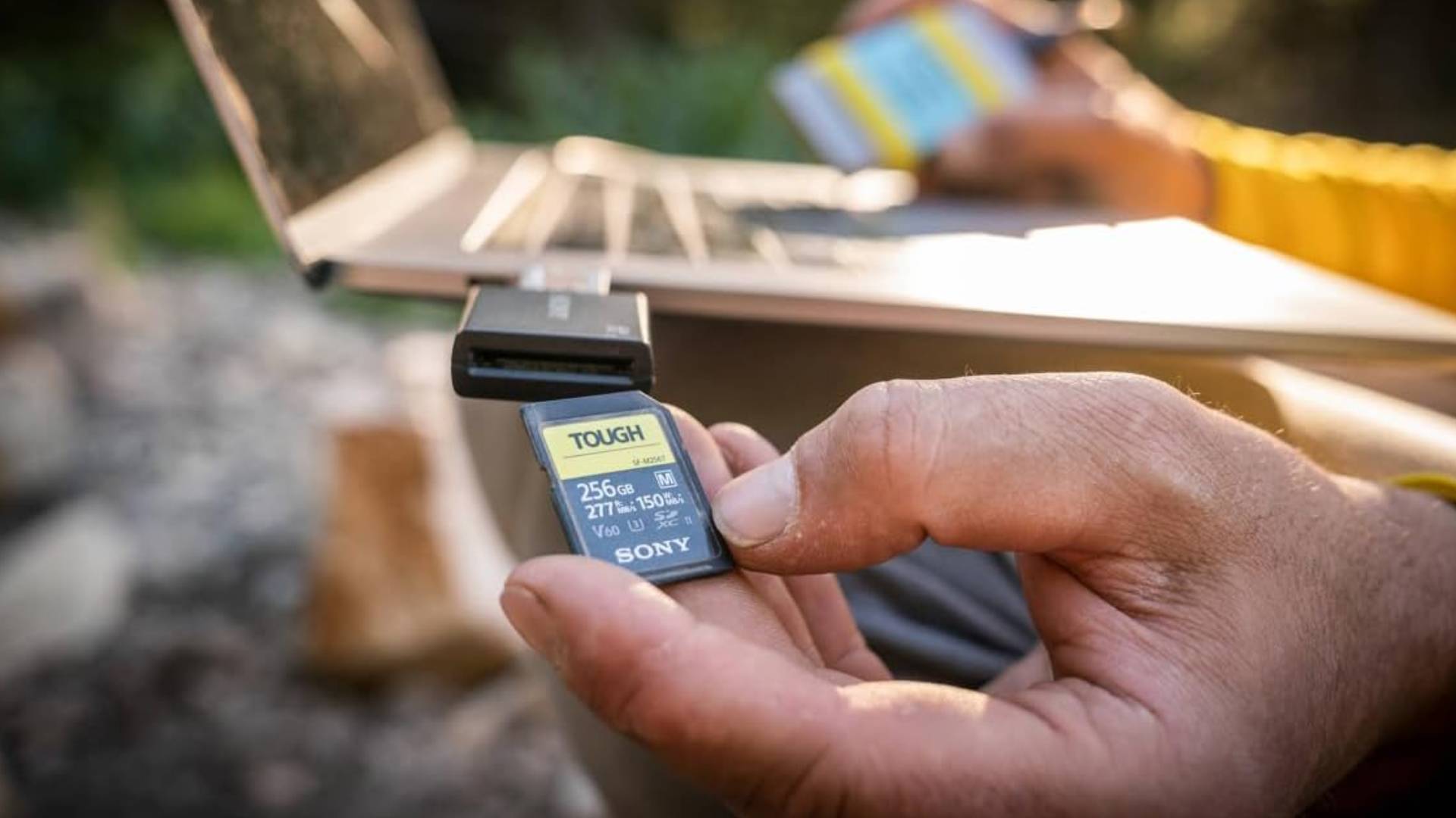 Official Sony marketing image showing a hand holding a Tough series memory card.