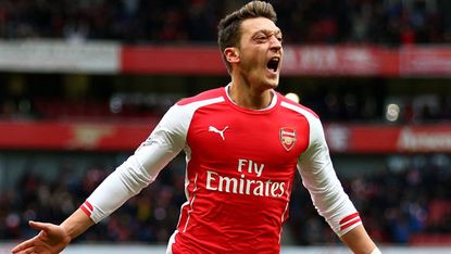 Mesut Ozil celebrates after scoring for Arsenal during the match between Arsenal and Aston Villa