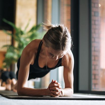 A woman doing a plank at home