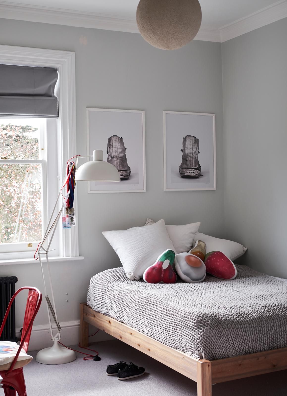 A small bedroom with a bed placed beside the window