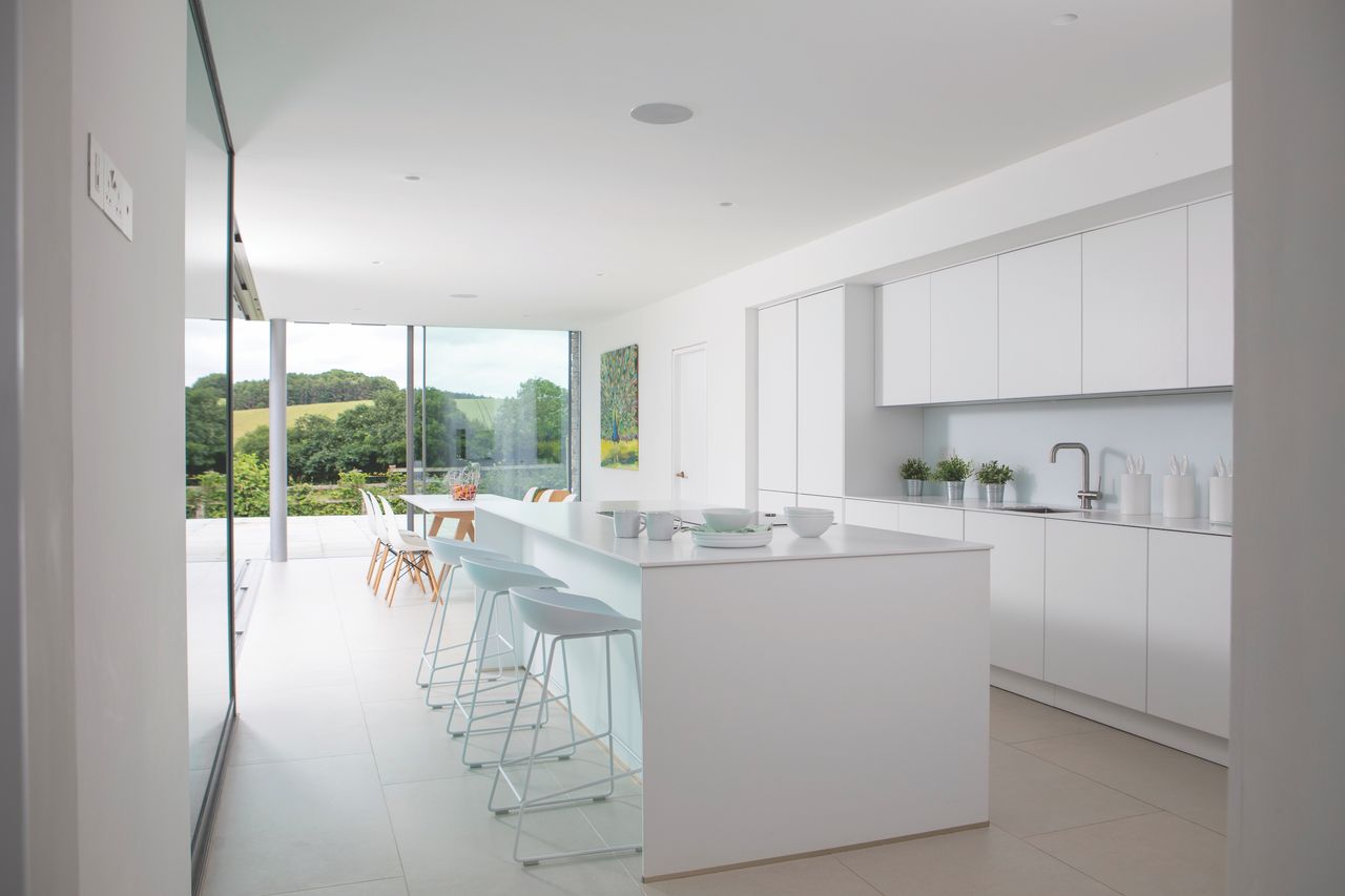 The extension has almost doubled the size of the living space, creating a light, open kitchen-diner, which links directly to the garden via sliding doors from Fine Line Aluminium.