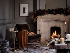 Dark Christmas living room scheme with garland over mantlepiece