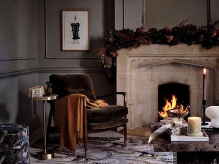 Dark Christmas living room scheme with garland over mantlepiece