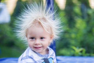 A little boy with hair standing on end from static electricity