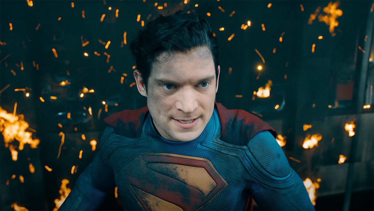 David Corenswet&#039;s Clark Kent/Kal-El standing against a burned building in 2025&#039;s Superman movie