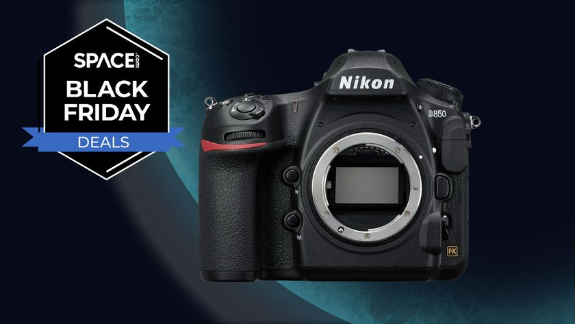 The Nikon D850 on a blue planet background with a black Space.com Black Friday deals badge in the upper left corner. 
